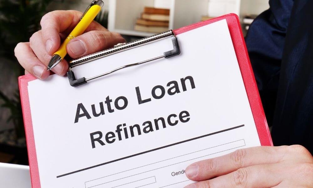 Man holding Refinance Auto Loans form